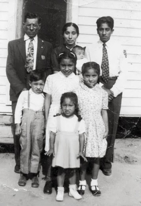 Rios family in front of old house